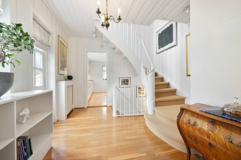 A living room filled with furniture and a staircase