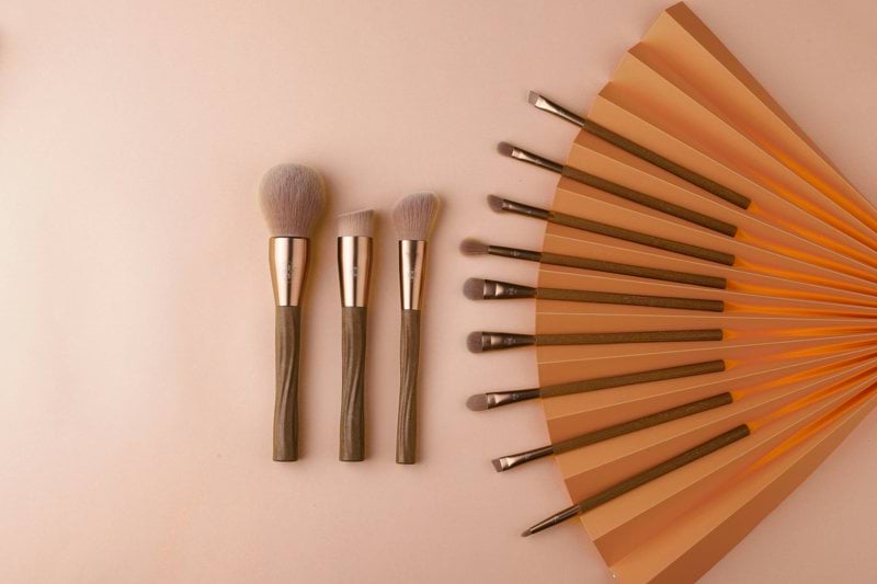 a collection of makeup brushes sitting on top of a table