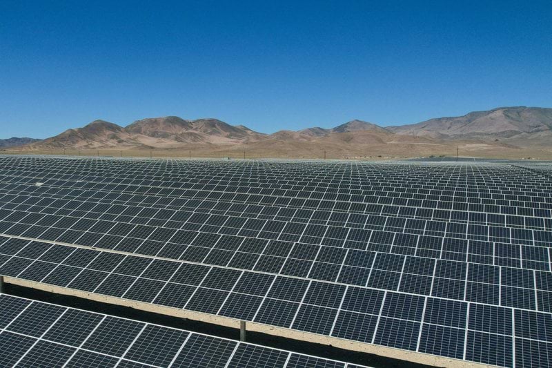 a large array of solar panels in a desert