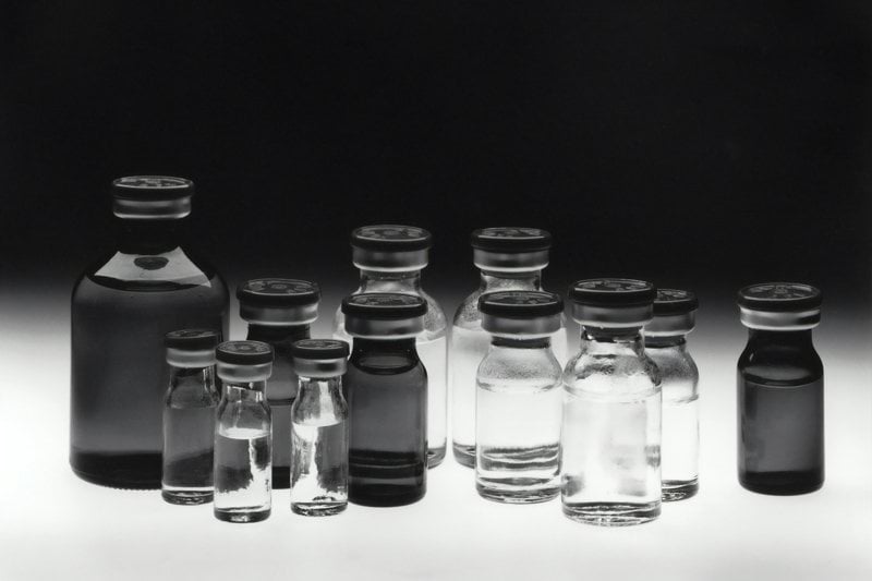 grayscale photo of glass tubes
