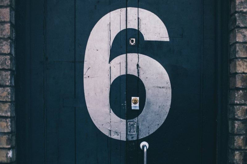 macro photography of blue wooden door painted with number 6