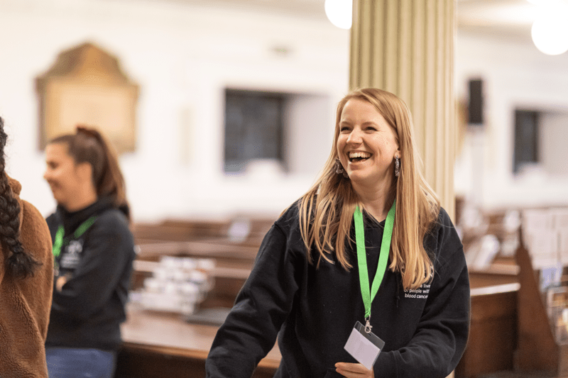 Anthony Nolan staff member laughing at christmas carols event
