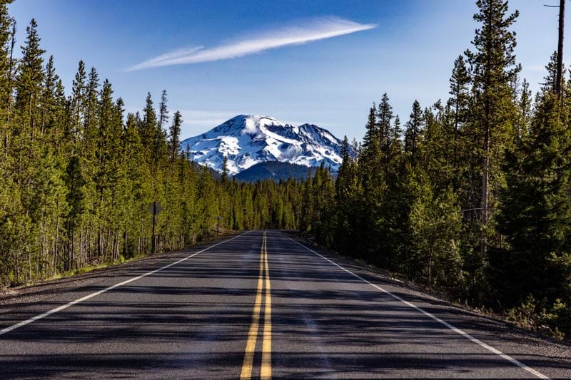 a road with a mountain in the background