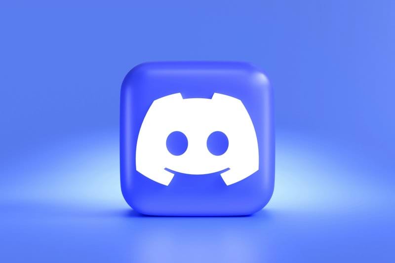 a square button with a smiley face on a blue background