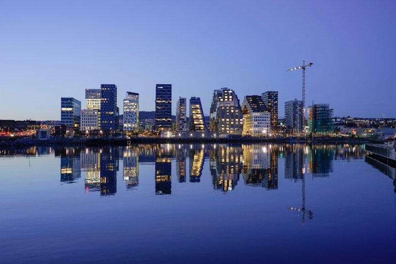 cityscape by water during golden hour
