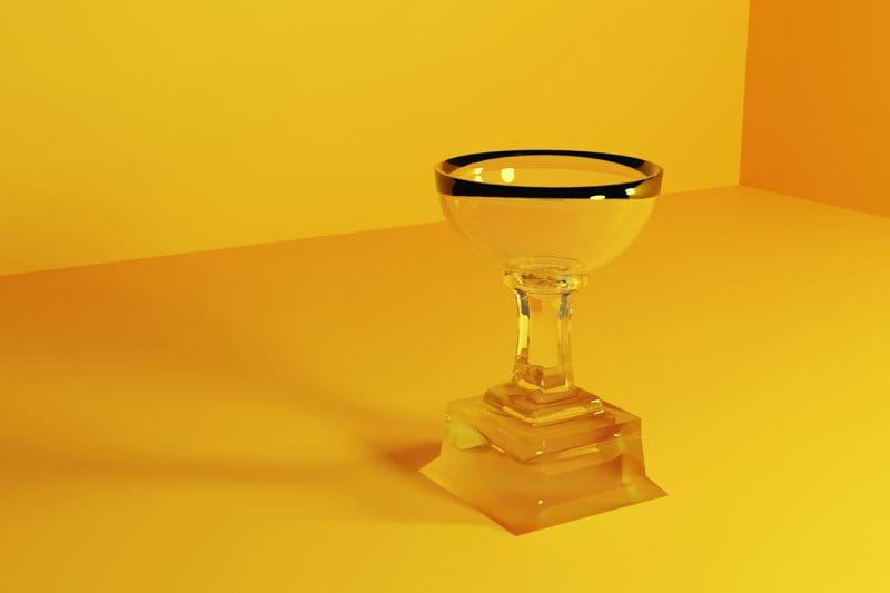 a glass with a black rim on a yellow background