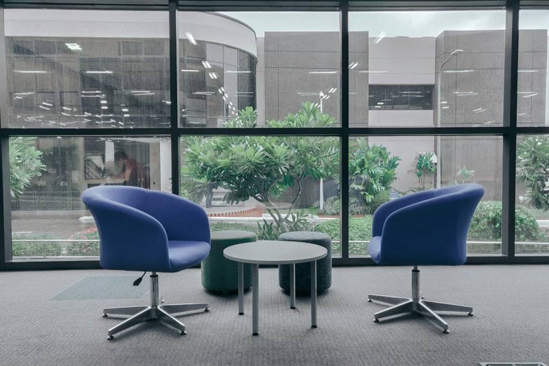 two blue leather rolling chairs