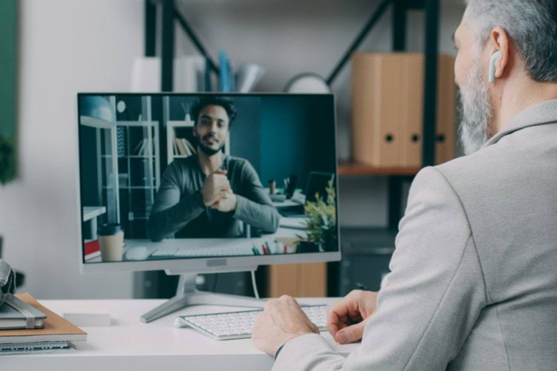 A man sitting at a desk in front of a computer