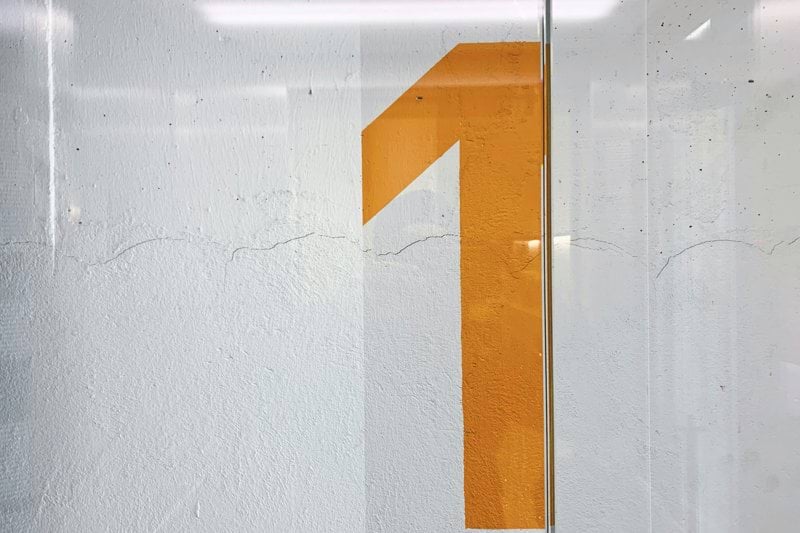 a white wall with a yellow number on it