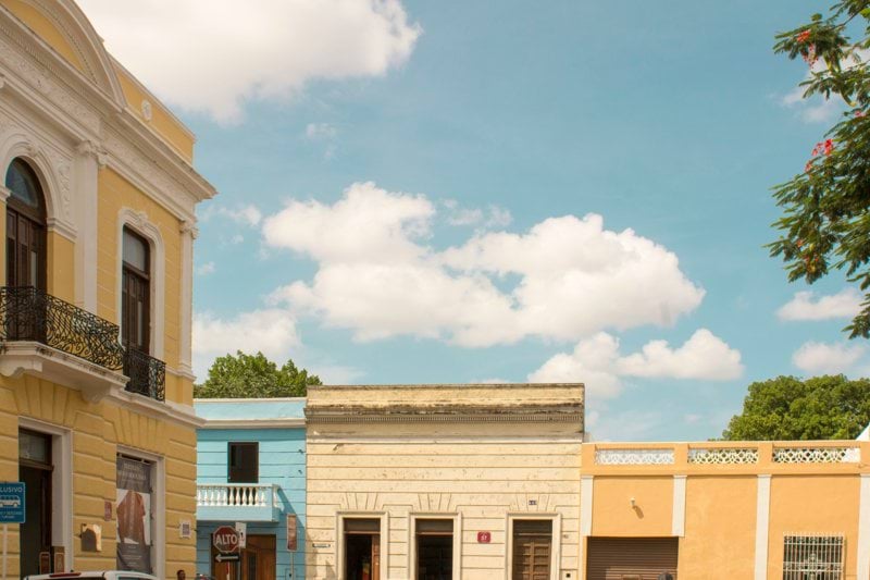 a row of buildings with cars parked in front of them