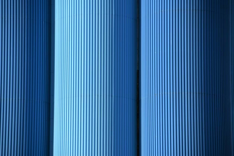 a close up of a row of blue pipes