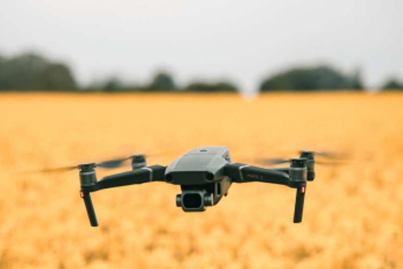 A drone hovering over a field