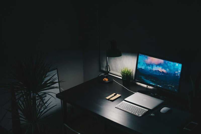 a desk with a computer monitor and keyboard on it