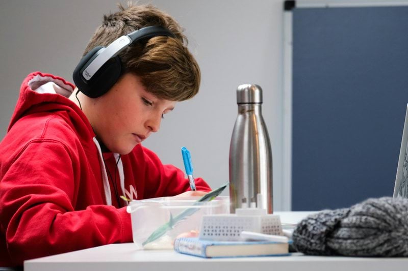 woman in red and white hoodie wearing black headphones