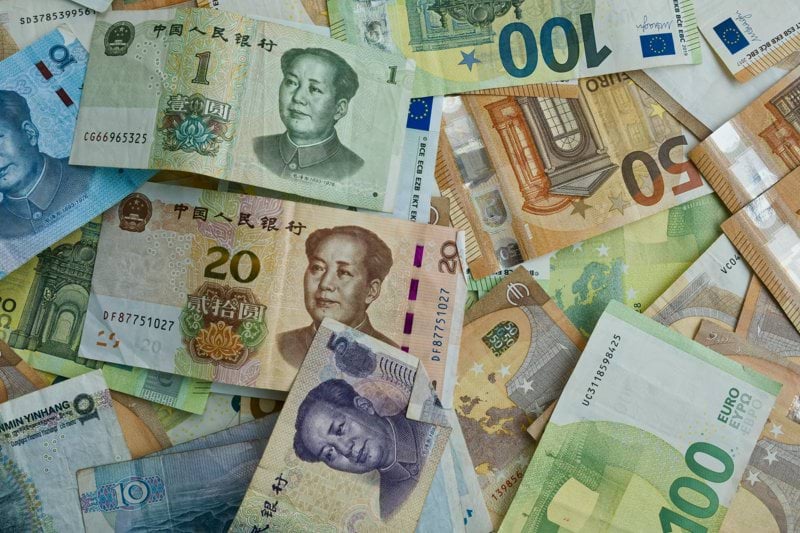 Chinese yuan and european euro banknotes scattered together