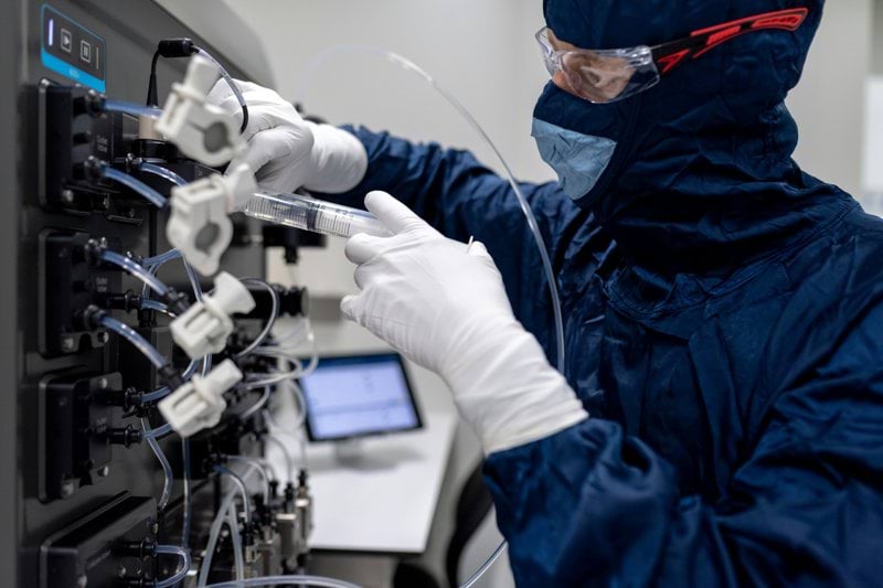a person in a lab coat holding a white object