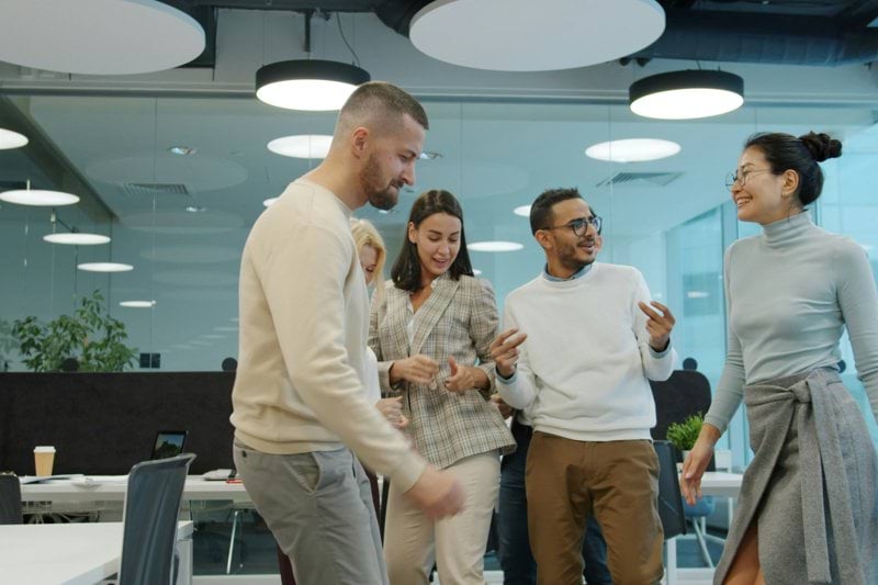 Colleagues dancing and celebrating in an office setting