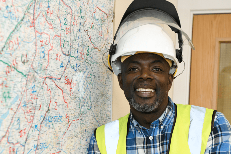 man leaning against wall smiling