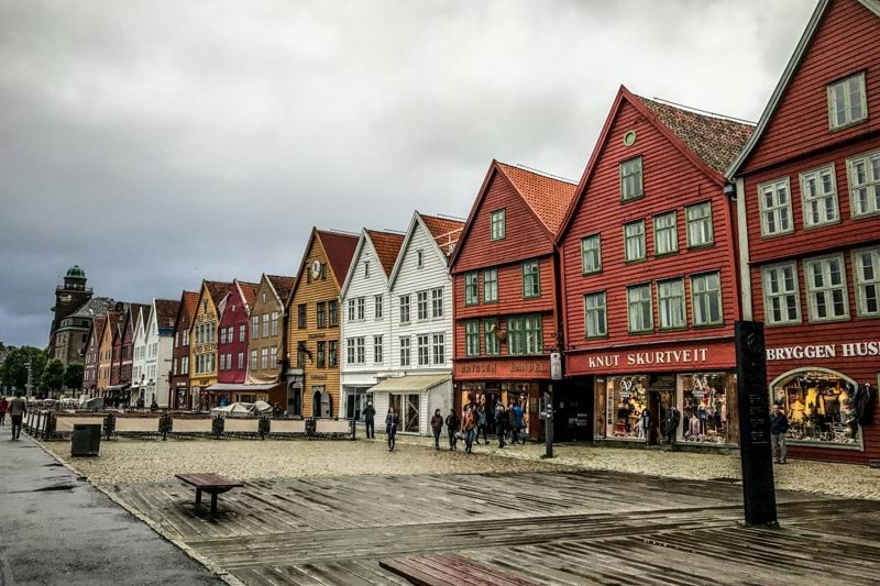 people standing near concrete houses