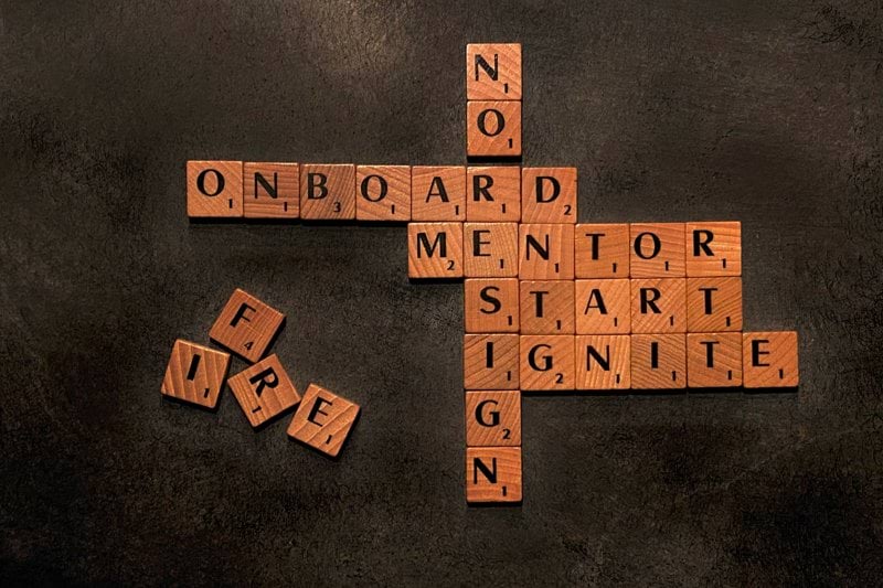 a scrabble of words that say no on board, mentor, start,