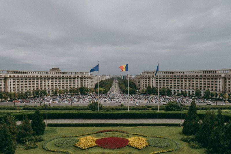 a large flower garden in front of a large building