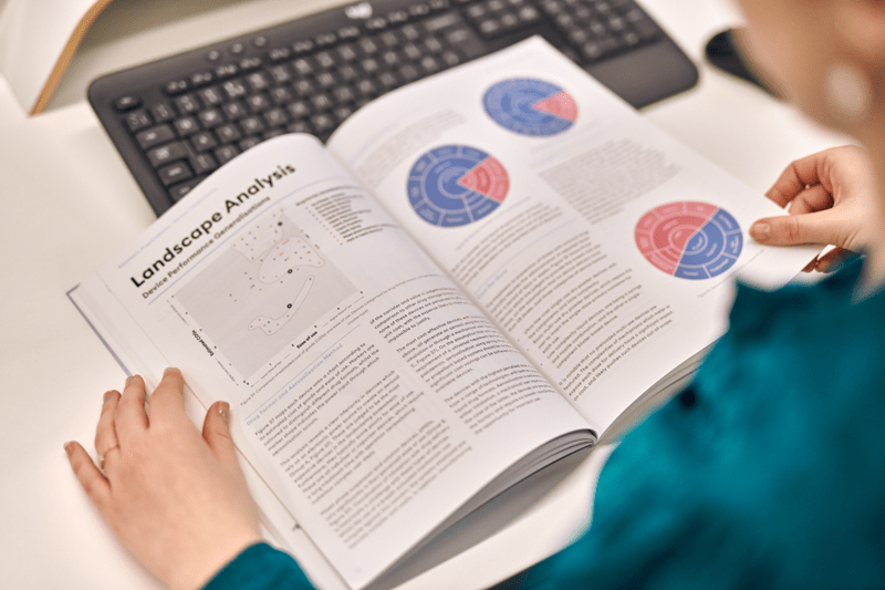 A person referencing a brochure of regulatory documentation