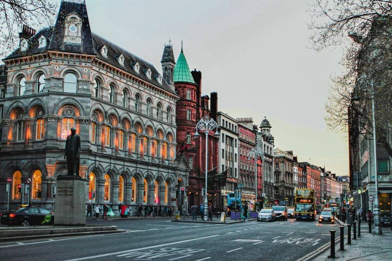 a city street with a clock tower in the middle of it