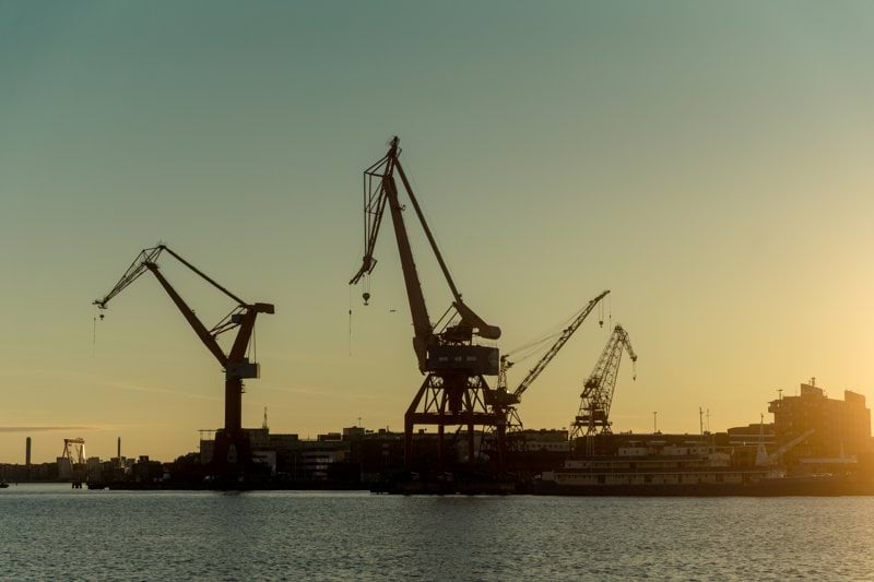 a group of cranes on a dock