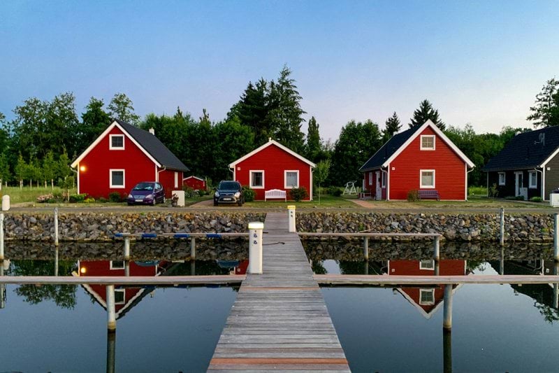 red and white house near body of water during daytime