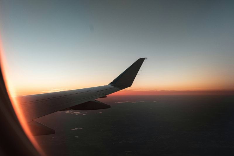 gray airplane flying during daytime