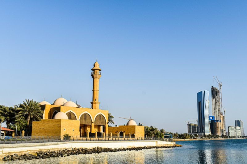 a building with a tower by the water