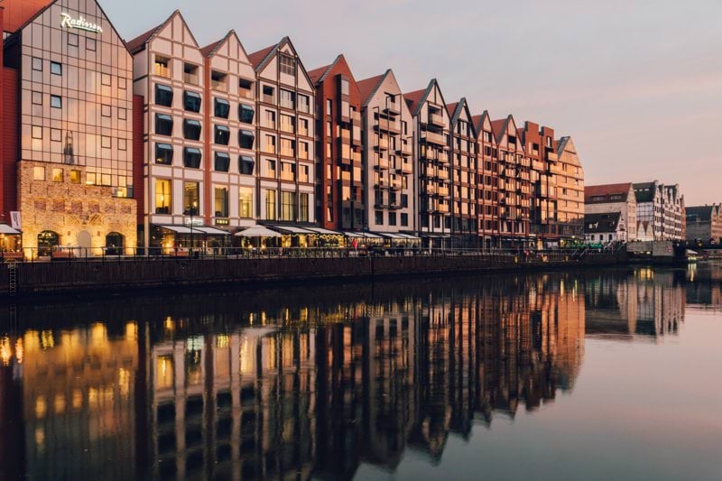 reflections of buildings on body of water