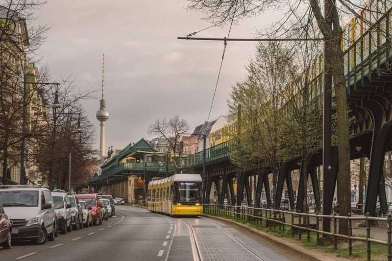 cars on road near green and white building during daytime