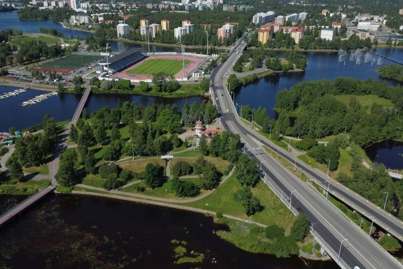a river with a bridge and trees