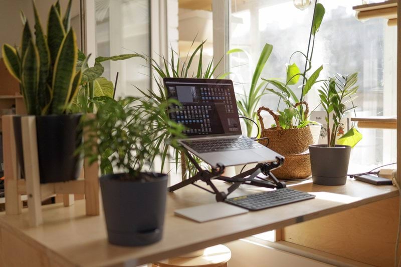 black laptop computer on brown wooden table