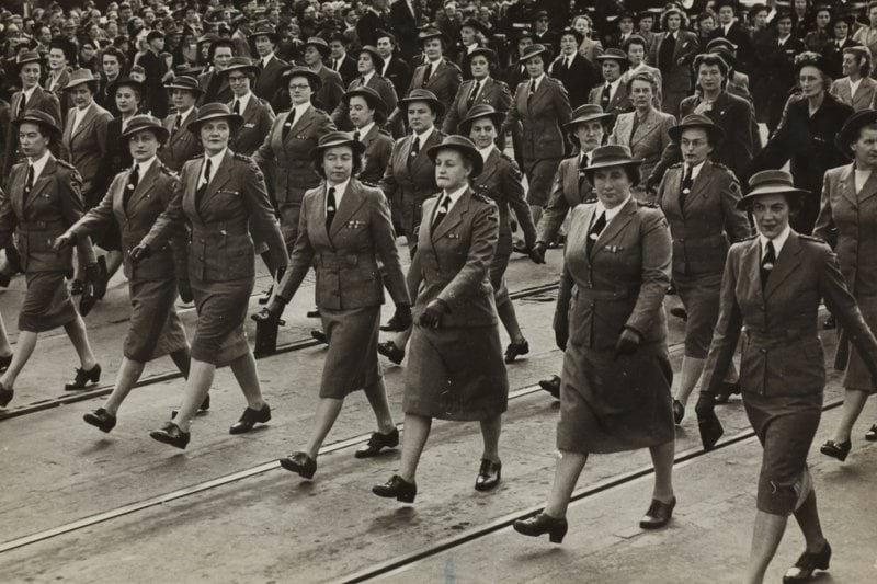 grayscale photography of group of women marching on road