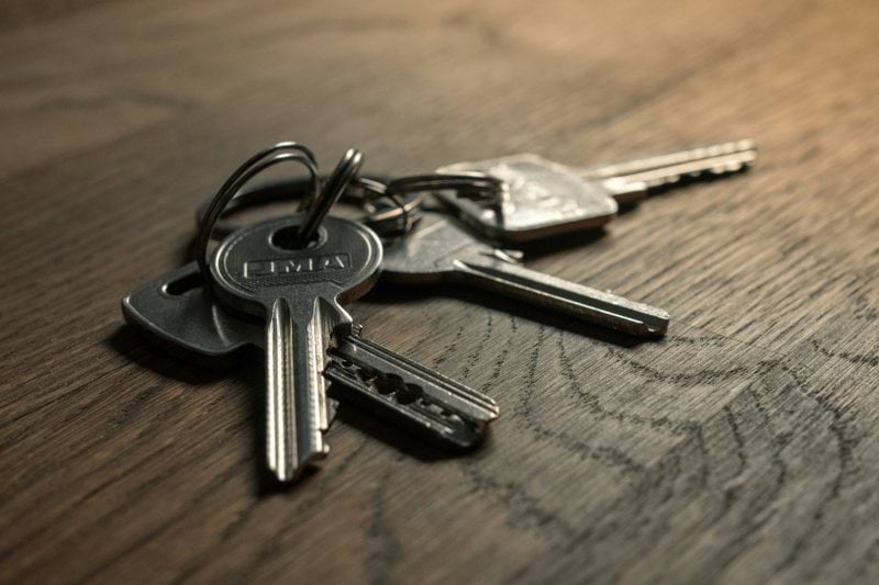 a bunch of keys sitting on top of a wooden table