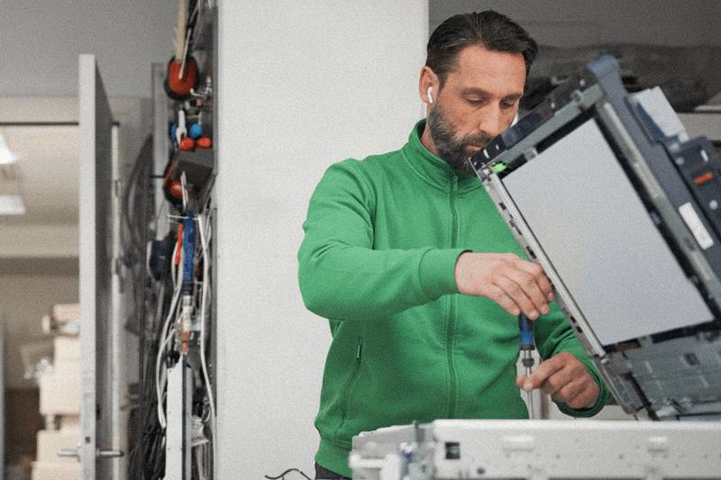 technician working with a copy printer