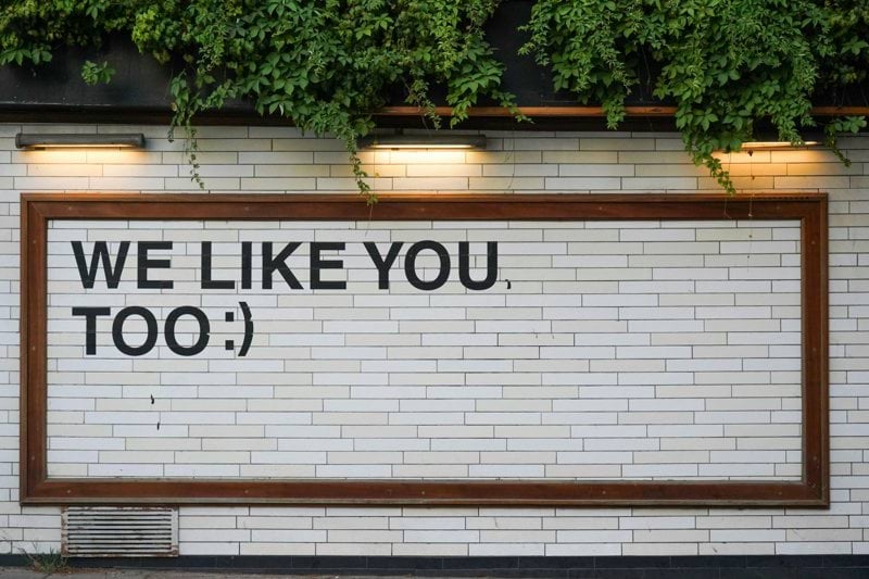 We Like You signage on white tile
