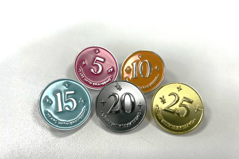 Image of 5 long service badges given to team members