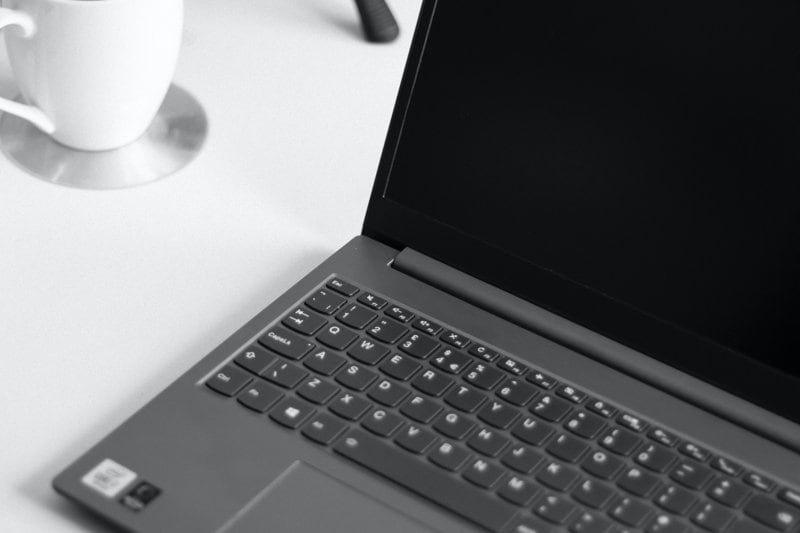 black laptop computer on white table