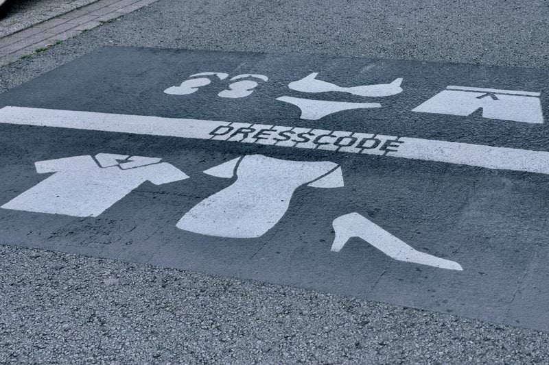 a parking space with a dress code painted on it