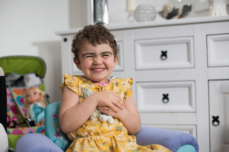 Young girl grinning in playroom