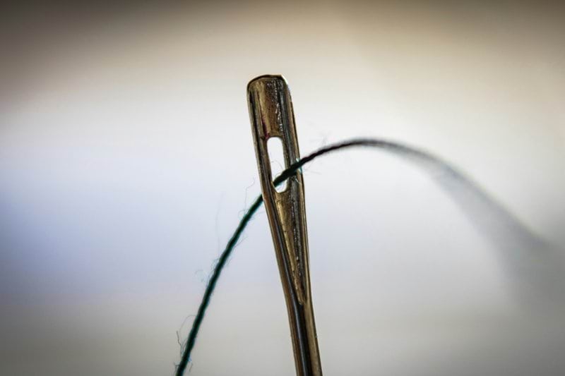 brown wooden clothes pin on white surface