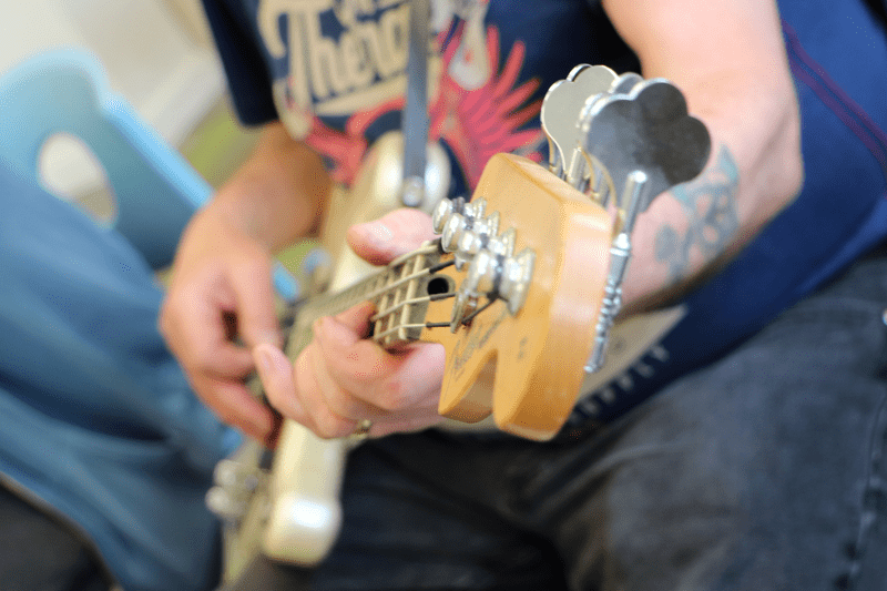 Hands playing a guitar