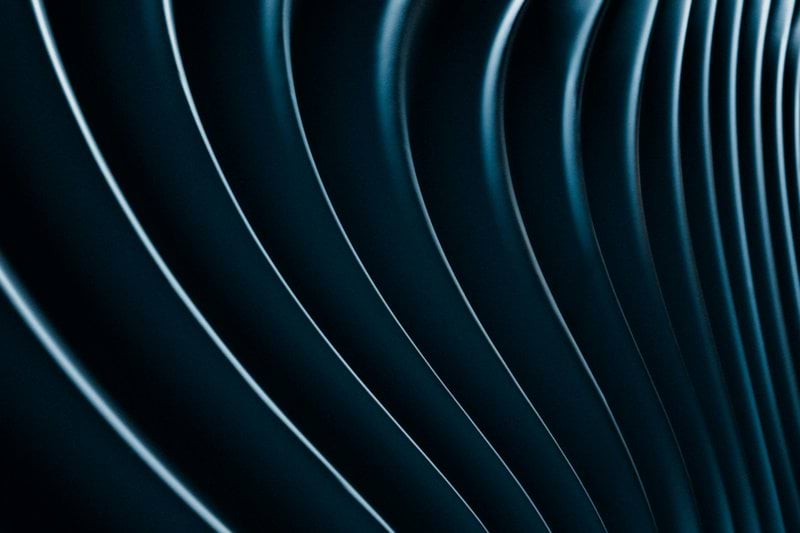 Abstract, wavy lines in a blue, metallic hue.