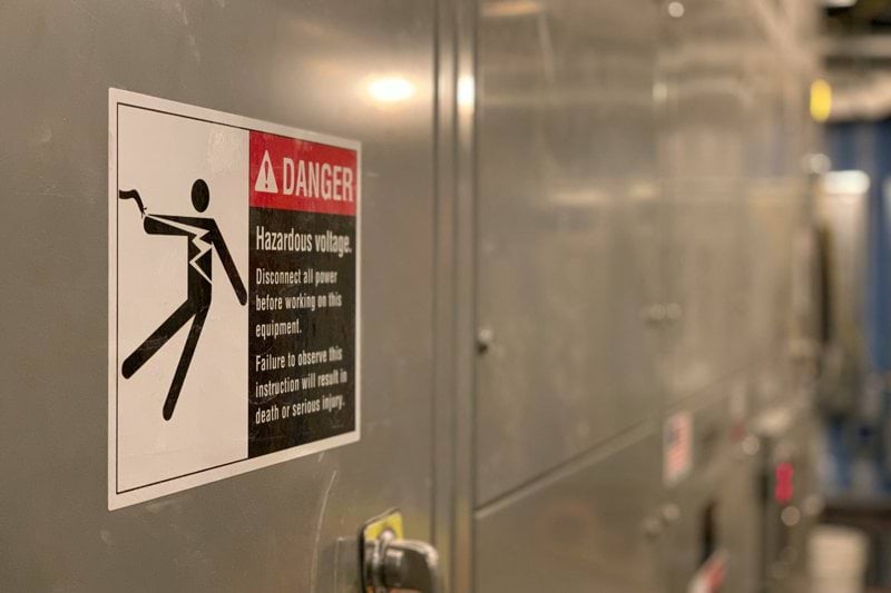 shallow focus photo of high voltage signage