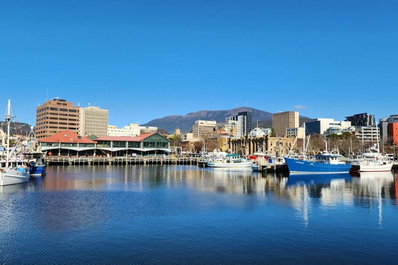 a body of water with boats in it and buildings in the back