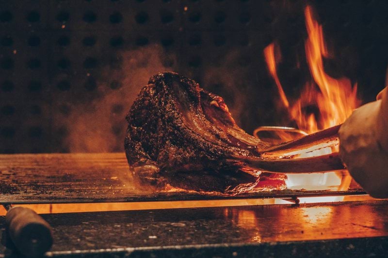 person barbecuing meat