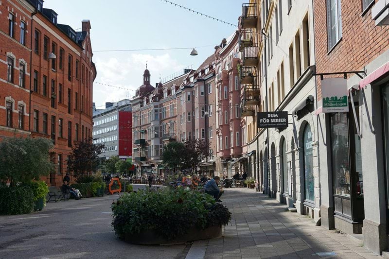 a city street lined with tall brick buildings